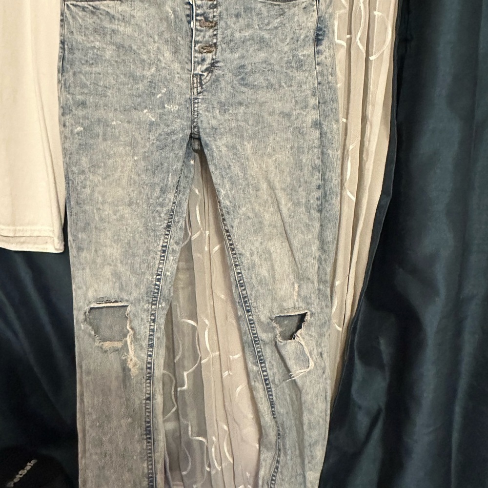 Distressed Light Blue Jeans with 4 button front closure